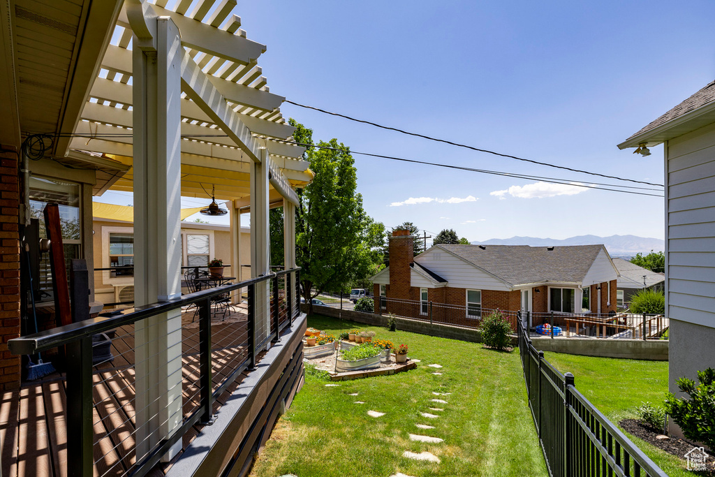 Fenced backyard with a pergola and a mountain view