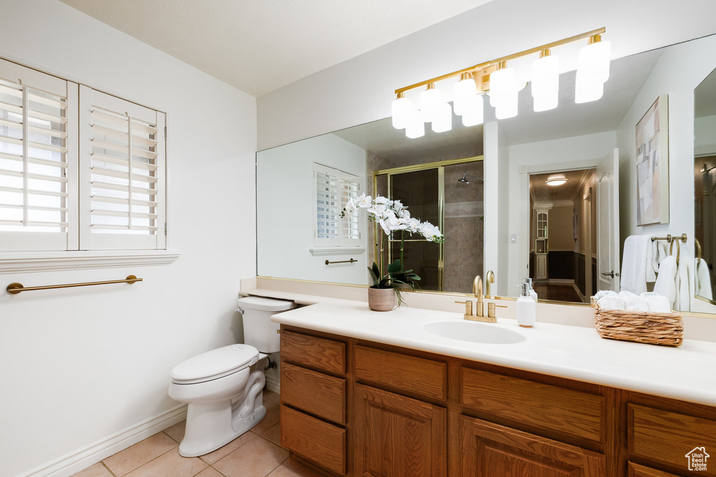 Full bathroom featuring tile patterned flooring, vanity, and a shower stall
