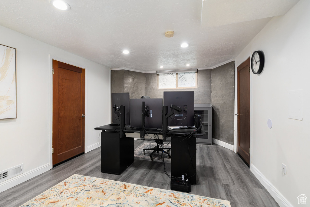 Office area with dark wood-type flooring and recessed lighting