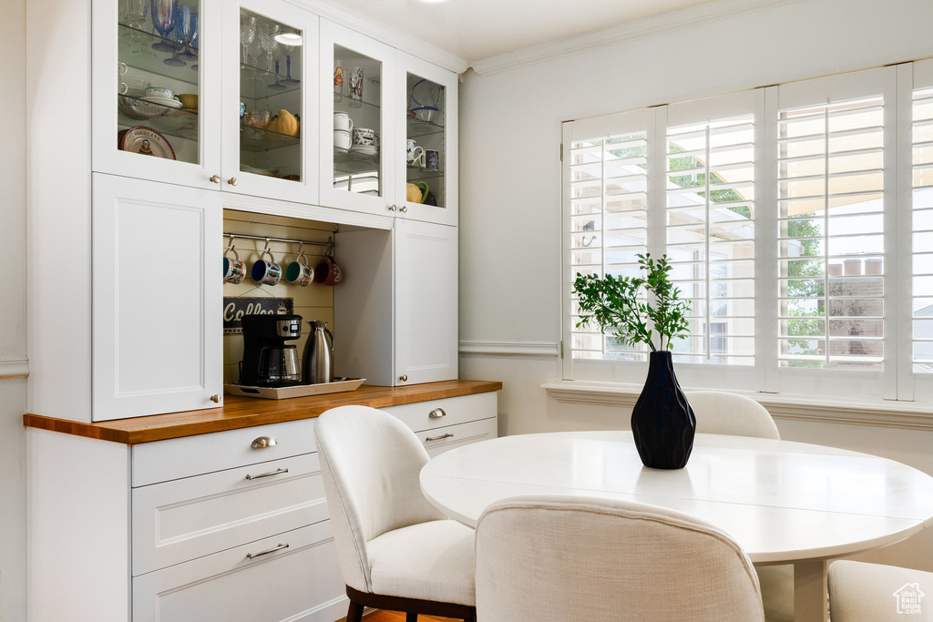 Dining room with plenty of natural light and ornamental molding