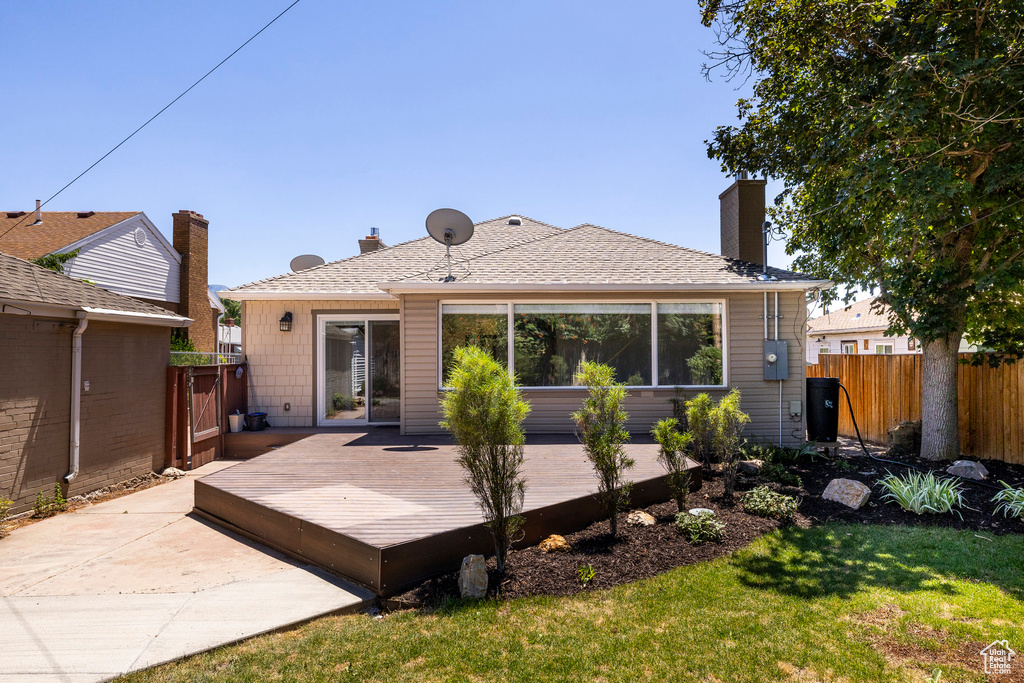Rear view of property featuring a deck and a chimney