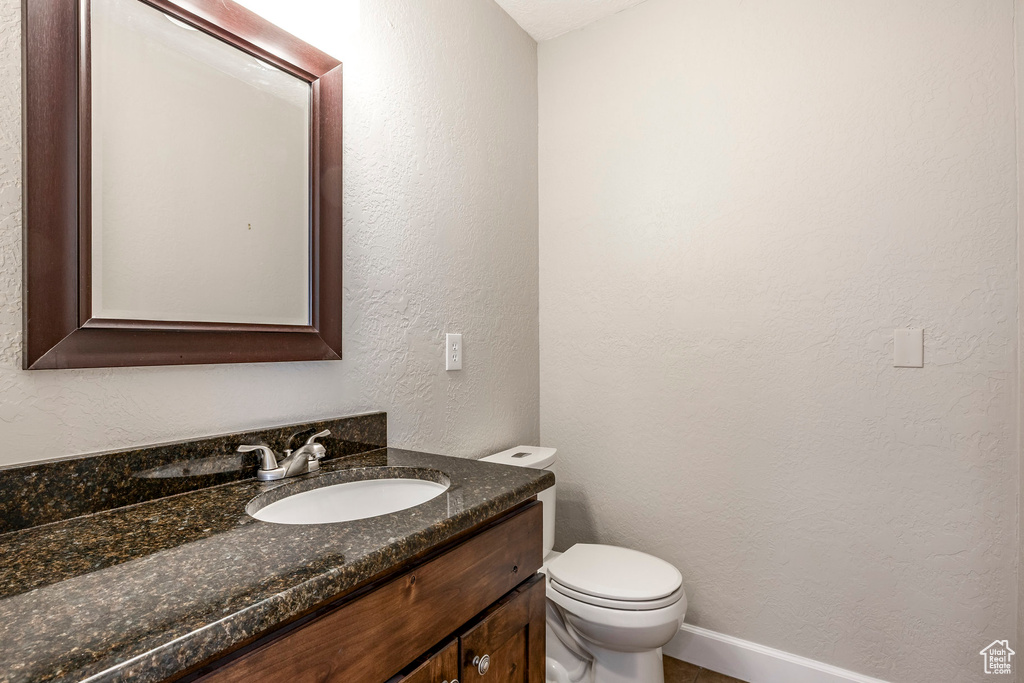 Bathroom featuring vanity and a textured wall