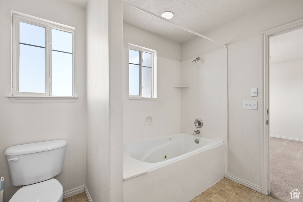 Bathroom featuring toilet and tub / shower combination
