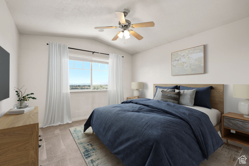 Bedroom with vaulted ceiling, light carpet, and a ceiling fan