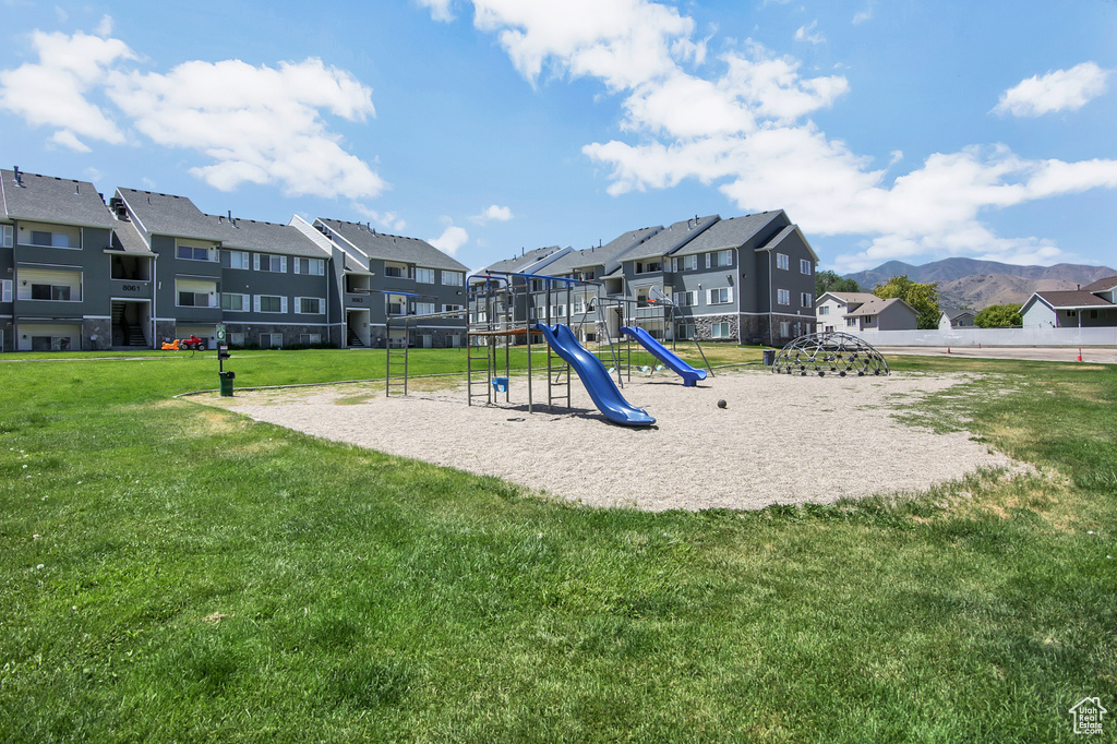 Community playground featuring a residential view, a lawn, and a mountain view