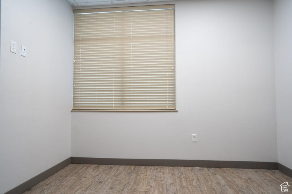 Empty room featuring baseboards and wood finished floors