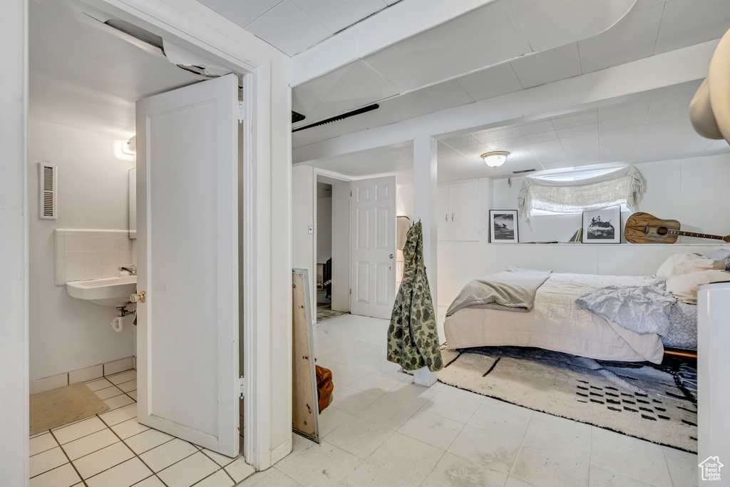 Bedroom with a sink and ensuite bathroom