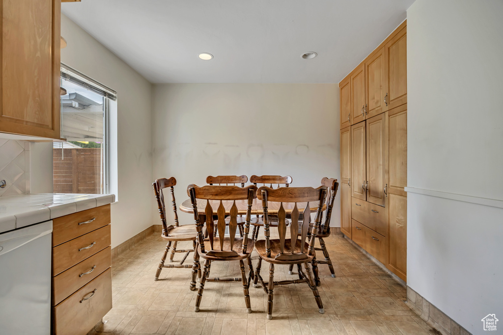 Dining area with recessed lighting and baseboards