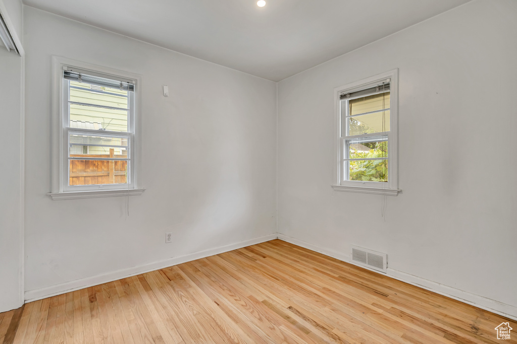 Unfurnished room featuring plenty of natural light, wood finished floors, and recessed lighting