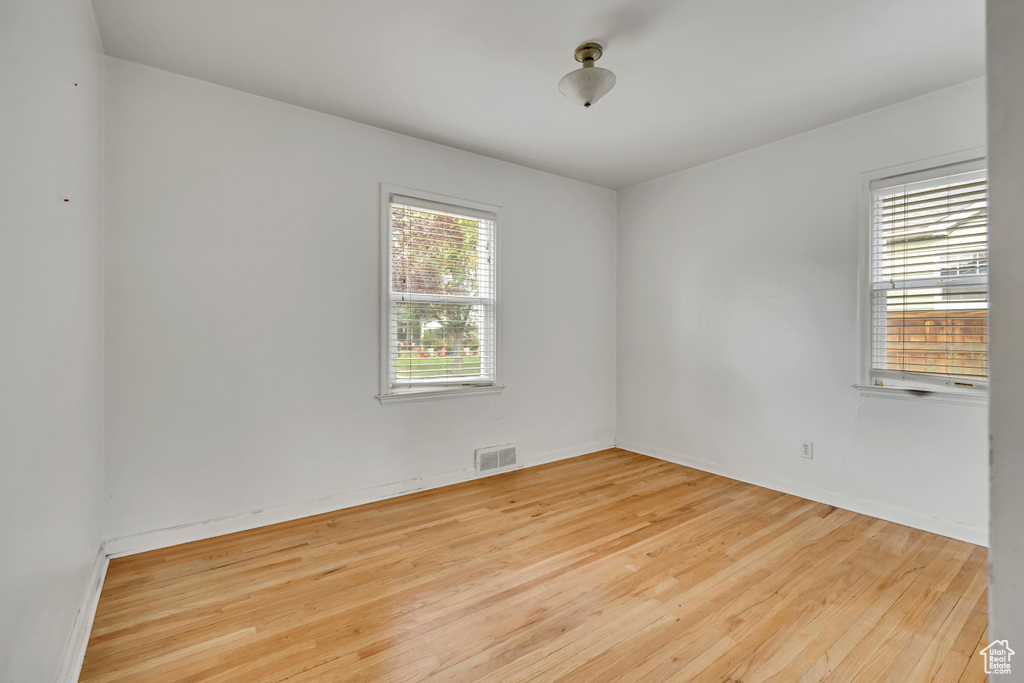 Spare room with wood finished floors and baseboards