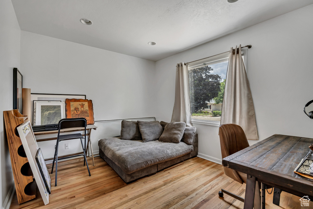 Home office with wood finished floors and baseboards