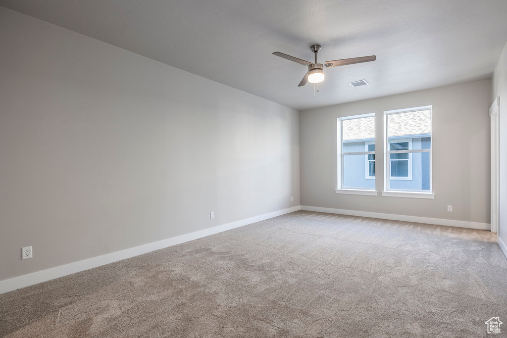 Spare room with carpet floors and ceiling fan