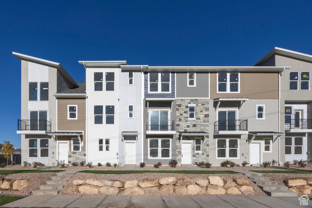 View of front of home with stone siding and stucco siding