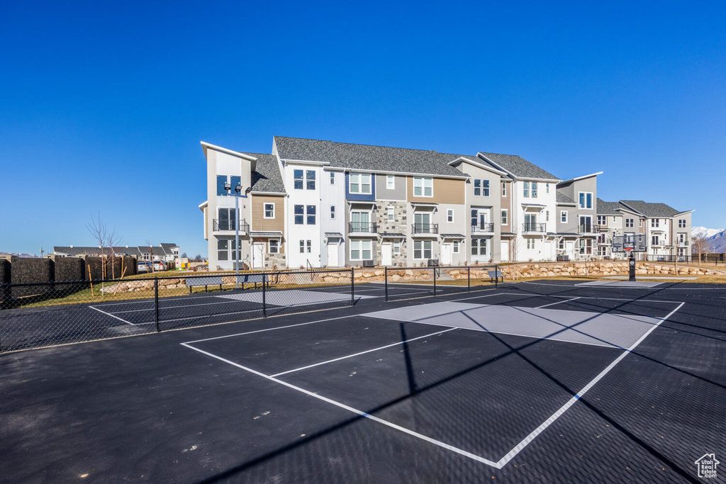 View of tennis court featuring a residential view
