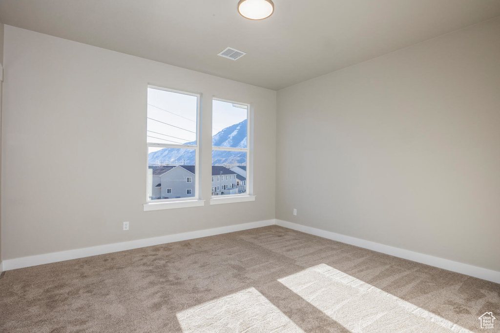 Empty room with carpet flooring and baseboards