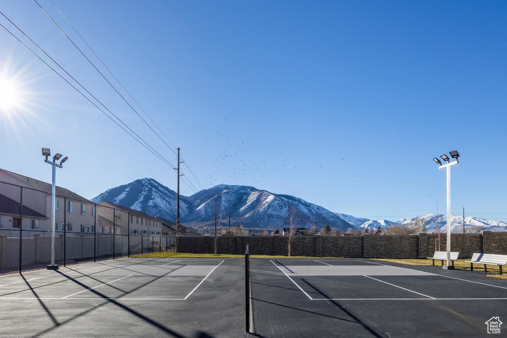 View of tennis court with a mountain view