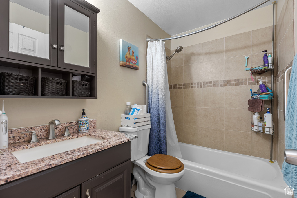 Bathroom featuring vanity and shower / tub combo
