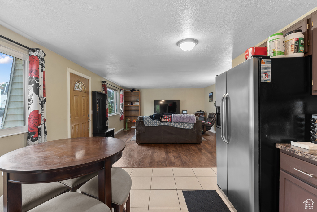 Living room featuring healthy amount of natural light, light tile patterned floors, and a textured ceiling