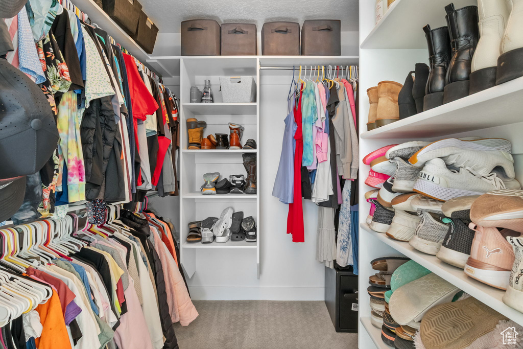 Spacious closet with carpet floors