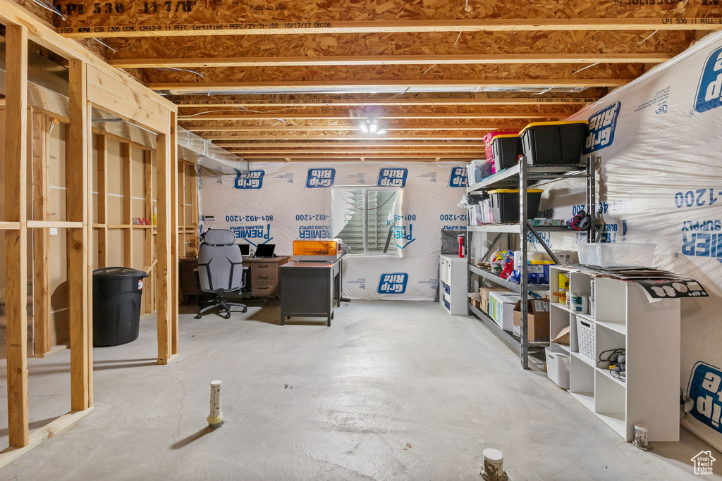 Unfinished below grade area with a desk