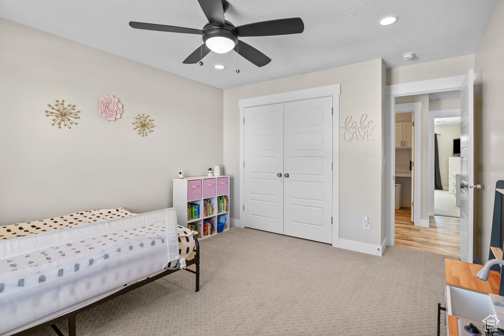 Carpeted bedroom with a closet, recessed lighting, and a ceiling fan