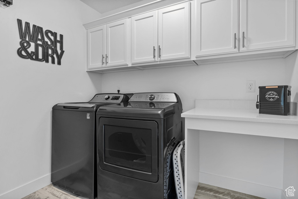 Laundry room with washing machine and clothes dryer and cabinet space