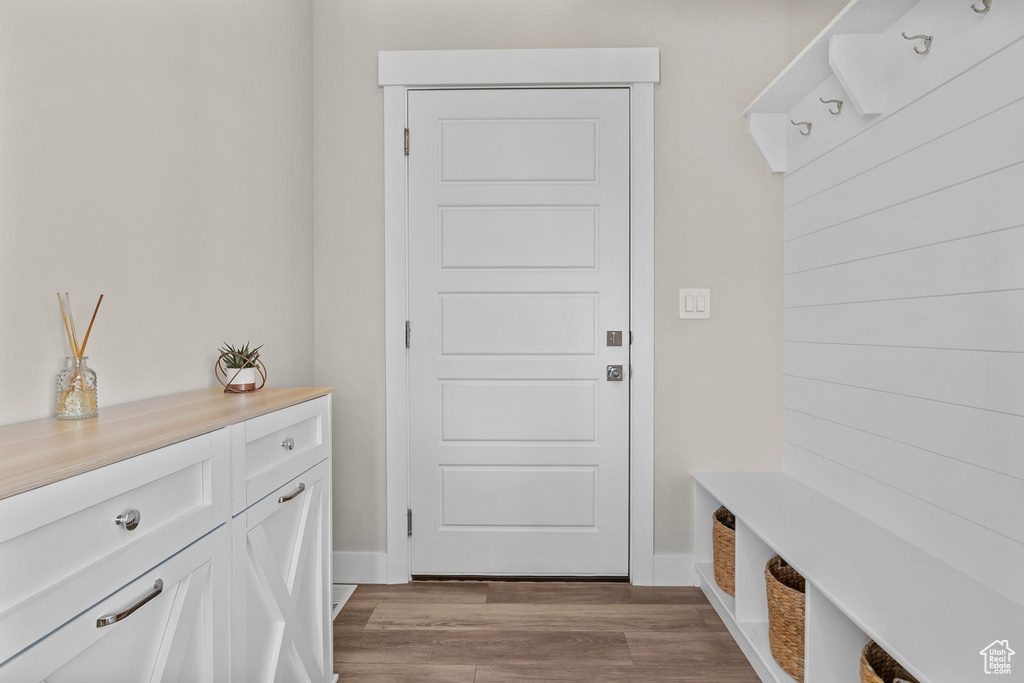 Mudroom with light wood-style floors and baseboards
