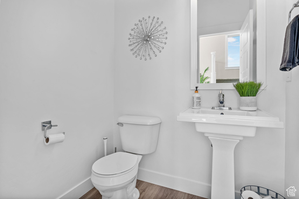 Bathroom featuring toilet and wood finished floors