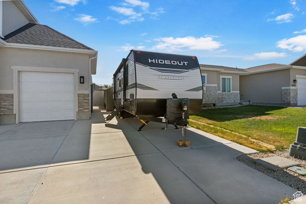 Exterior space featuring concrete driveway and a garage