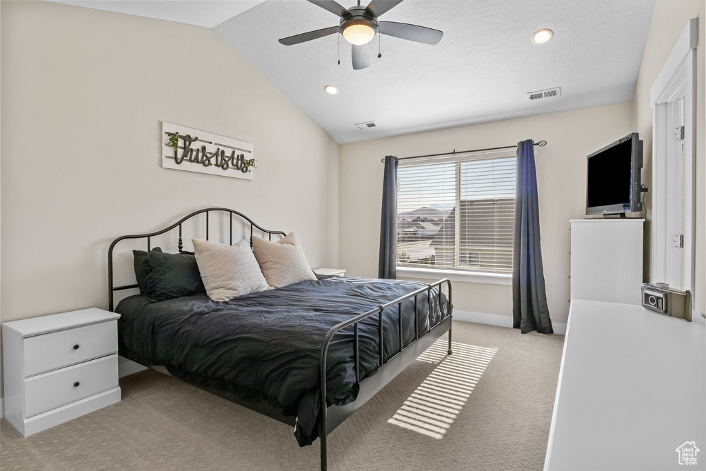 Bedroom with light colored carpet, lofted ceiling, ceiling fan, and recessed lighting