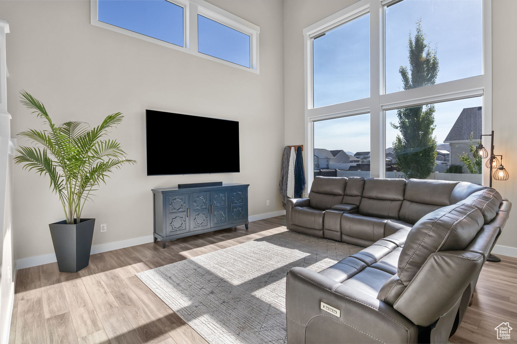 Living area with a high ceiling and wood finished floors