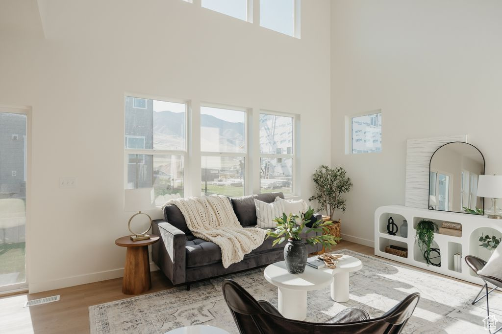 Living room with a towering ceiling and wood finished floors