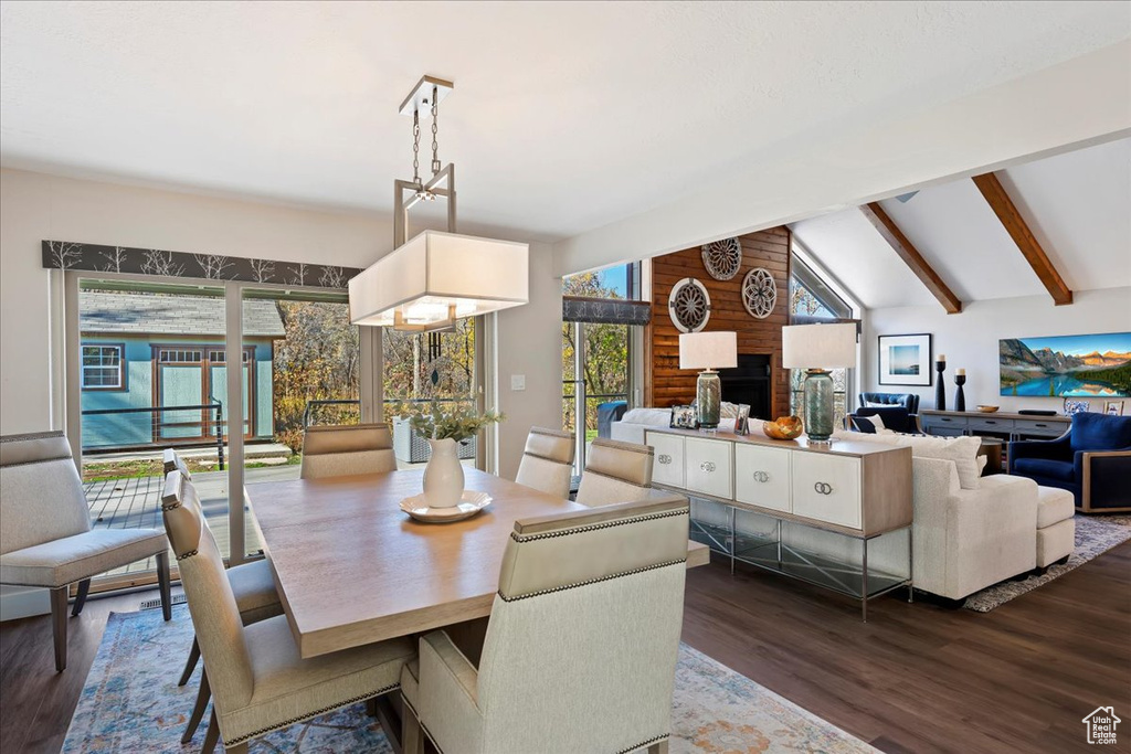 Dining room with dark wood finished floors and a brick fireplace