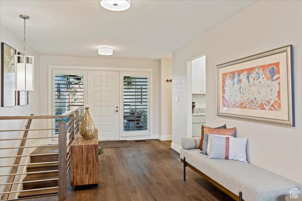 Foyer entrance featuring dark wood-type flooring and baseboards