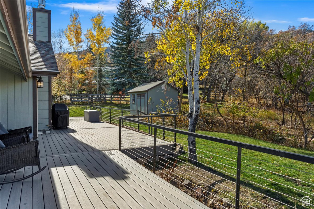 Deck with a shed and a yard