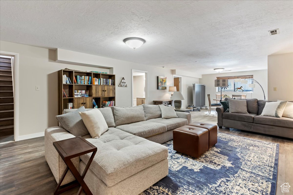 Living room with wood finished floors and a textured ceiling