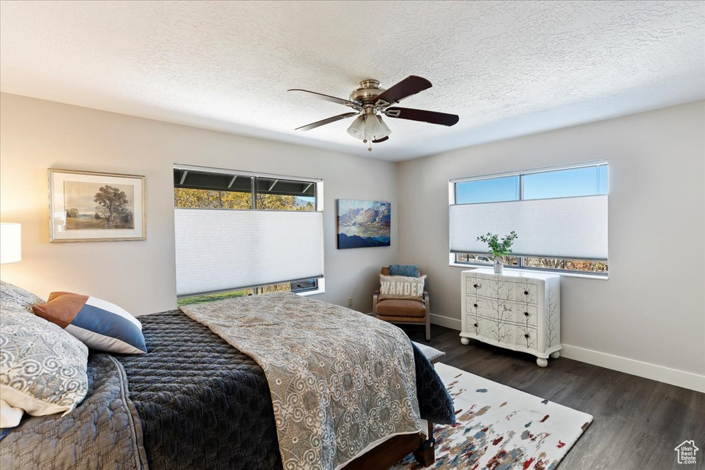 Bedroom featuring wood finished floors, a textured ceiling, and ceiling fan