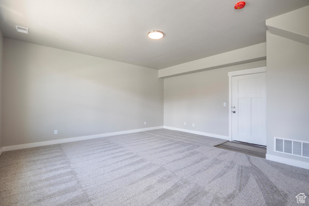 Carpeted empty room featuring baseboards