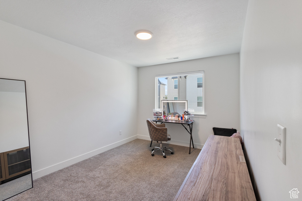 Office area featuring carpet floors and baseboards