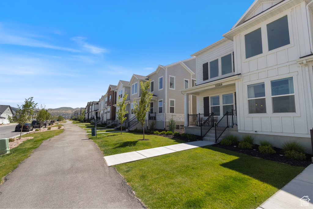 View of community featuring a residential view and a lawn