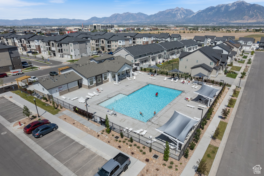 Aerial perspective of suburban area with a pool area and mountains