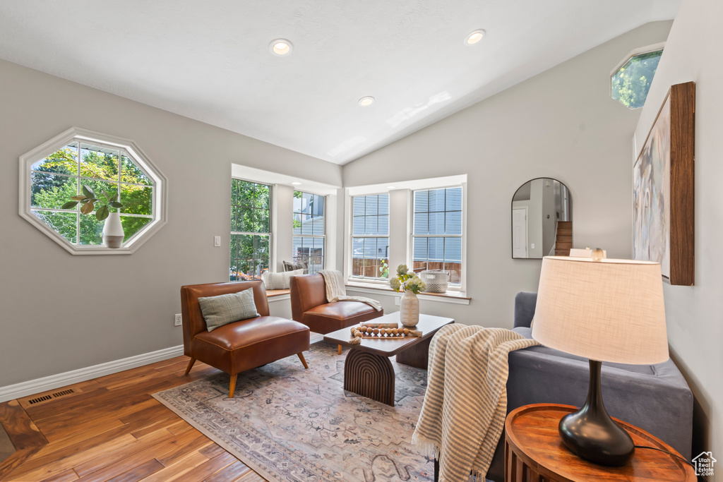 Sitting room with lofted ceiling, wood finished floors, and recessed lighting