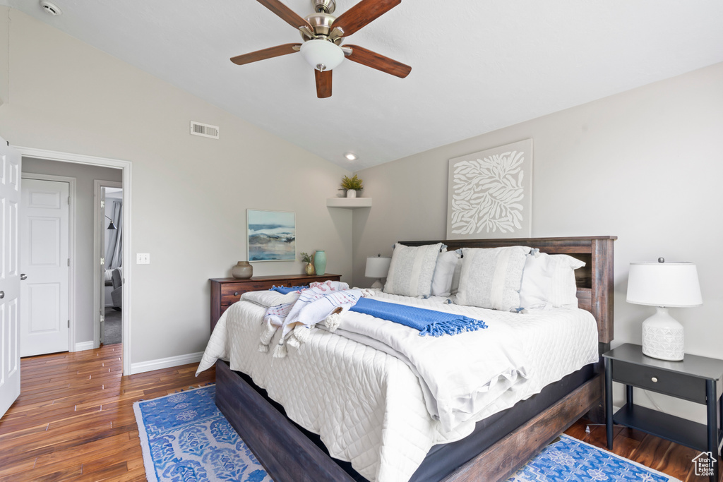 Bedroom with wood finished floors, lofted ceiling, and a ceiling fan