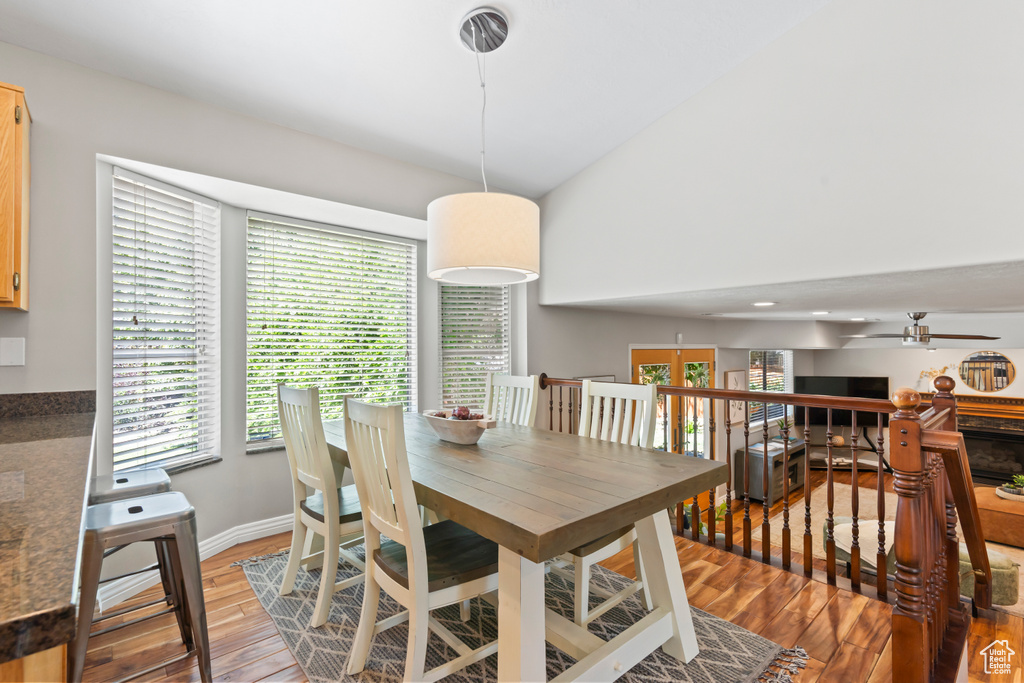 Dining space with healthy amount of natural light, ceiling fan, and light wood-type flooring