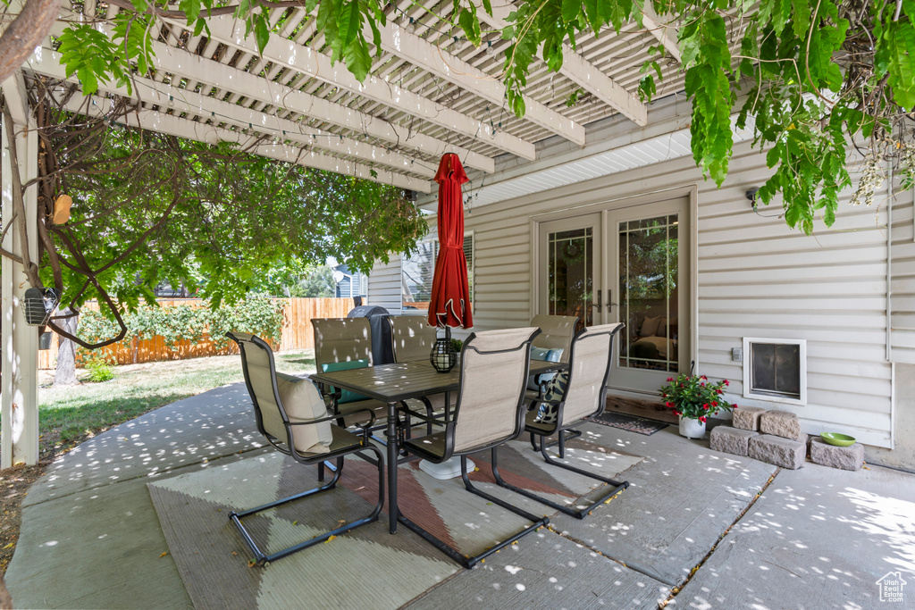 View of patio with a pergola, outdoor dining area, and french doors