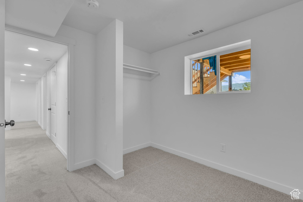 Spacious closet with carpet floors