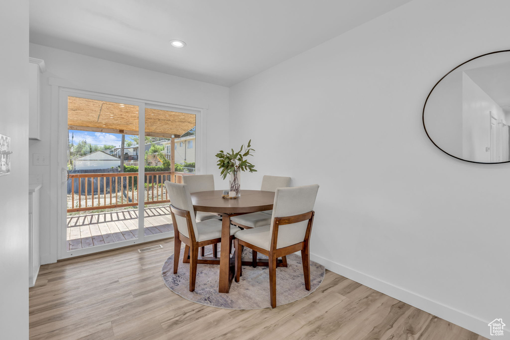 Dining space with light wood-style flooring and recessed lighting