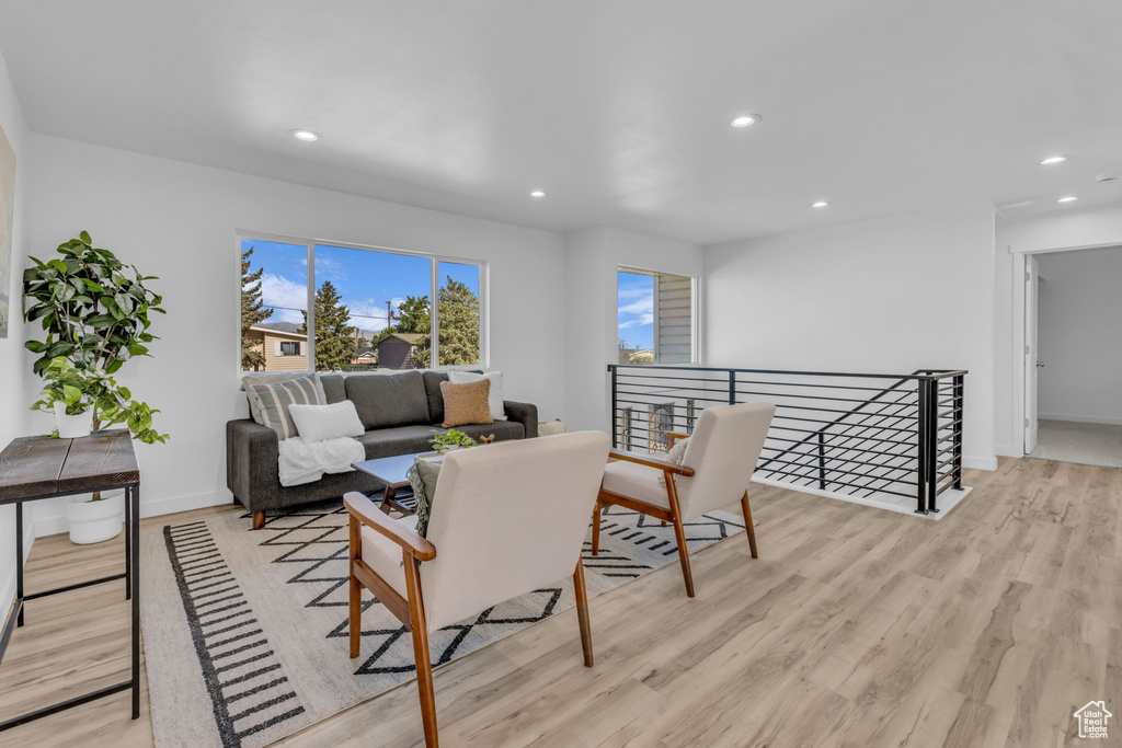 Living area with recessed lighting and light wood-style floors