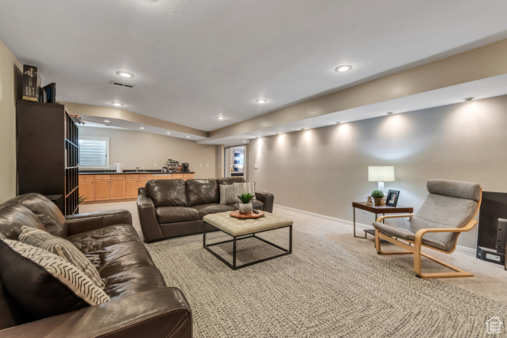 Living room featuring light colored carpet and recessed lighting