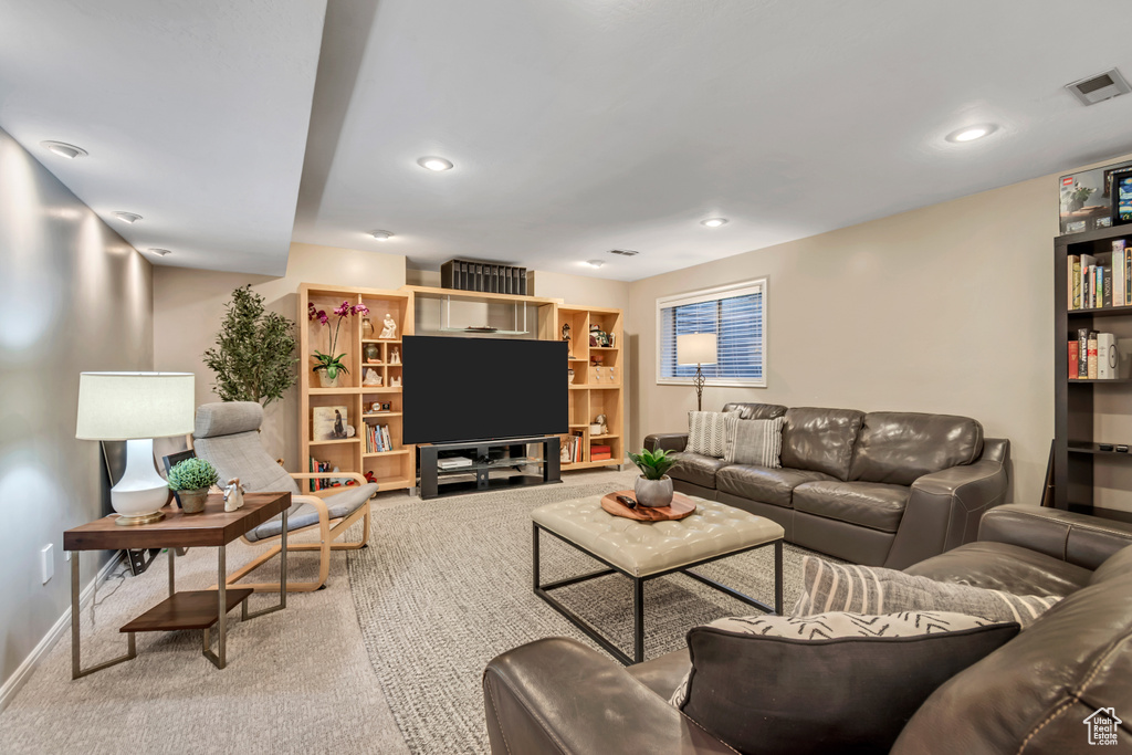 Carpeted living room with baseboards and recessed lighting